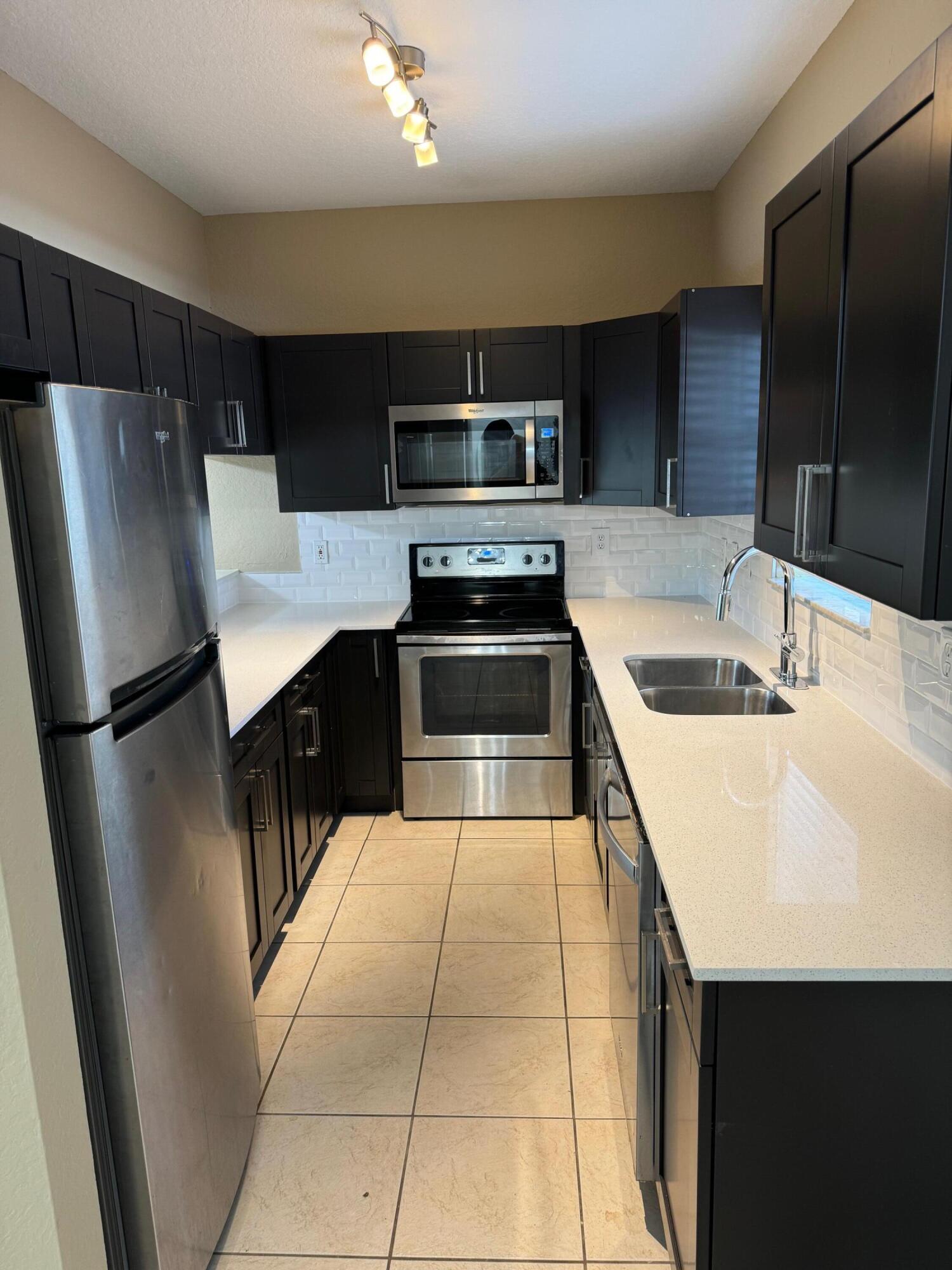 a kitchen with stainless steel appliances a refrigerator and a sink