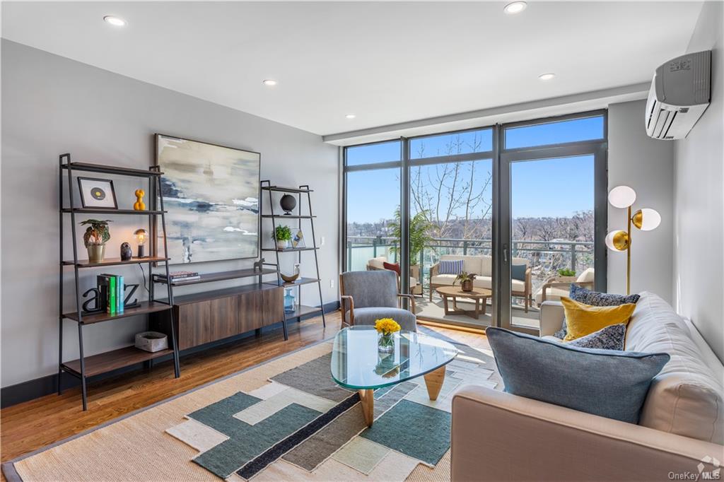 a living room with furniture a rug and a large window