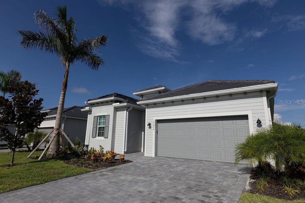 a front view of a house with a yard and garage