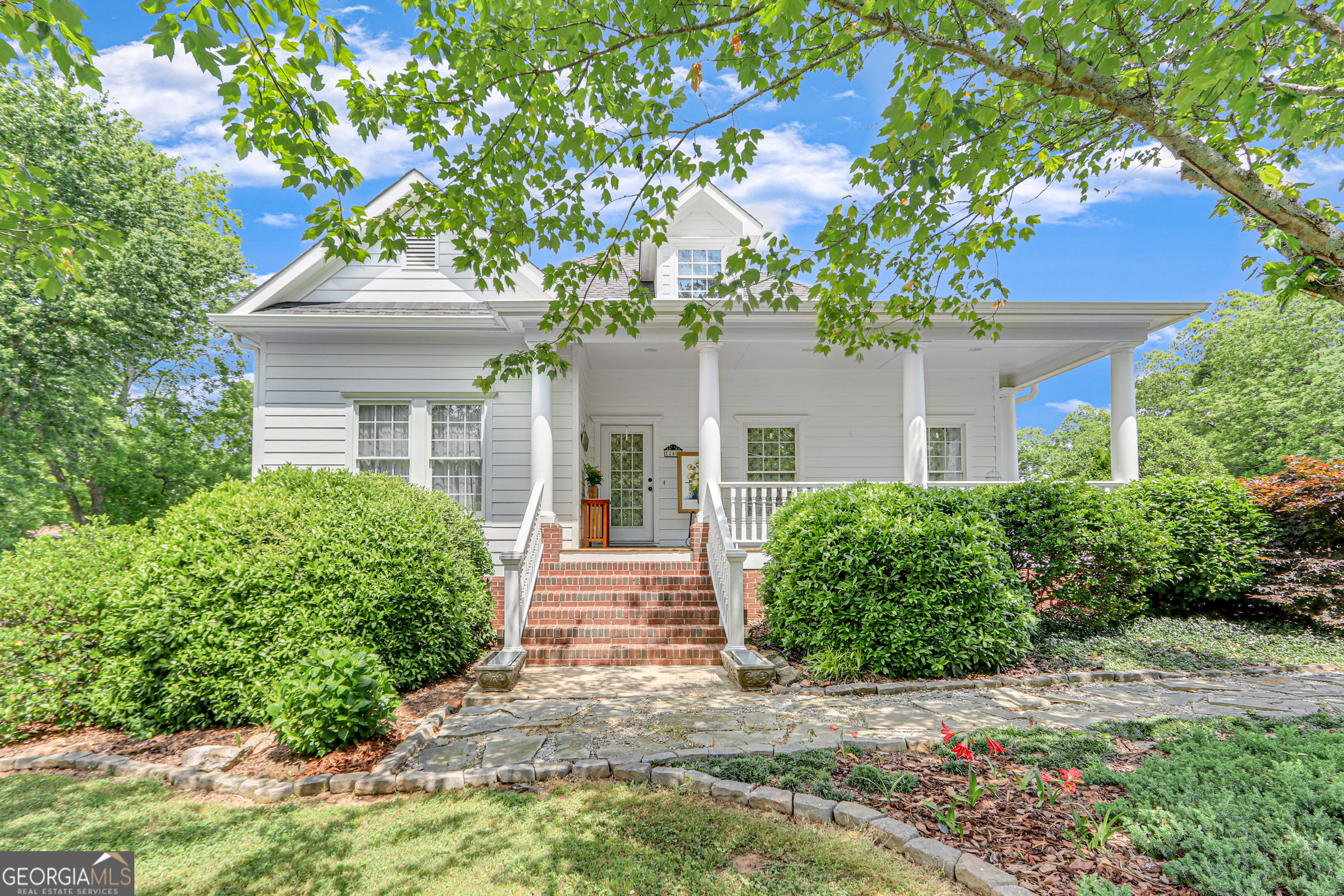 a front view of a house with a garden