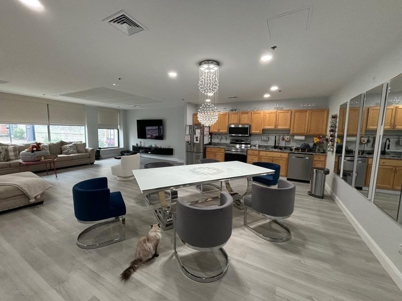 a kitchen with a table chairs refrigerator and microwave