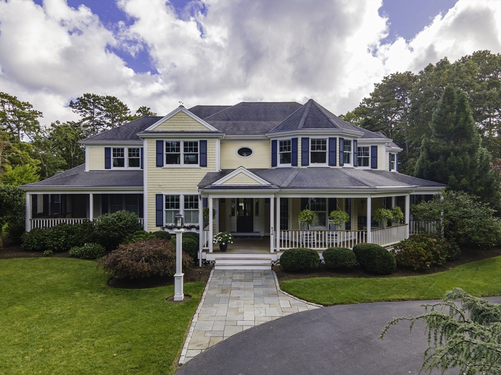 a front view of a house with garden and porch