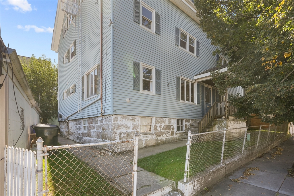 a view of a house with backyard and sitting area