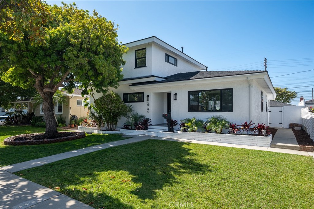 a front view of house with yard and green space