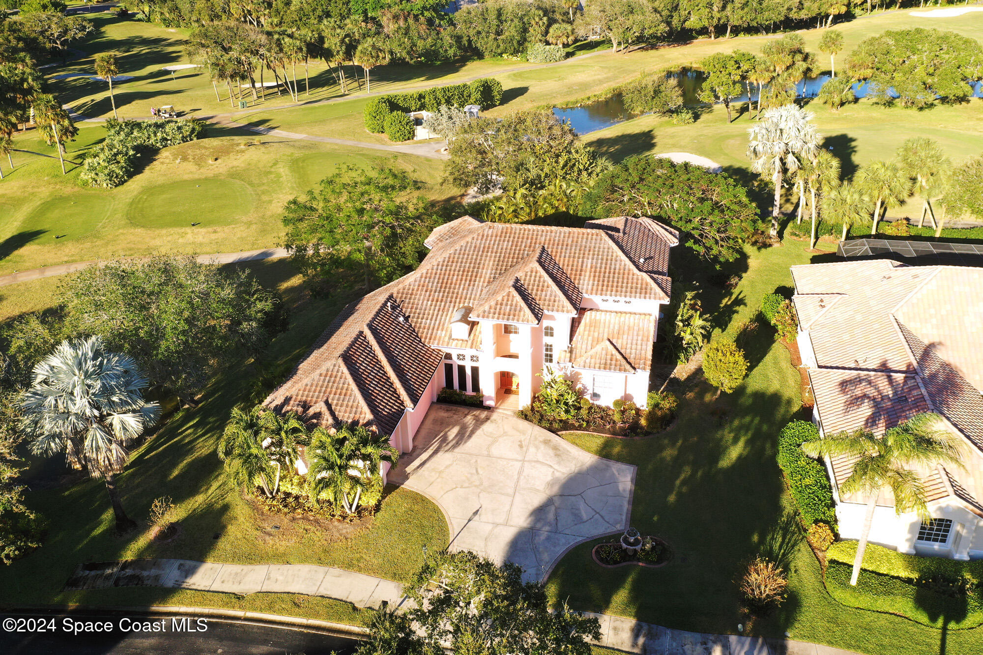 an aerial view of a house with a yard swimming pool and outdoor seating