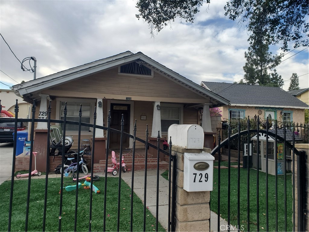 a front view of a house with yard porch and furniture