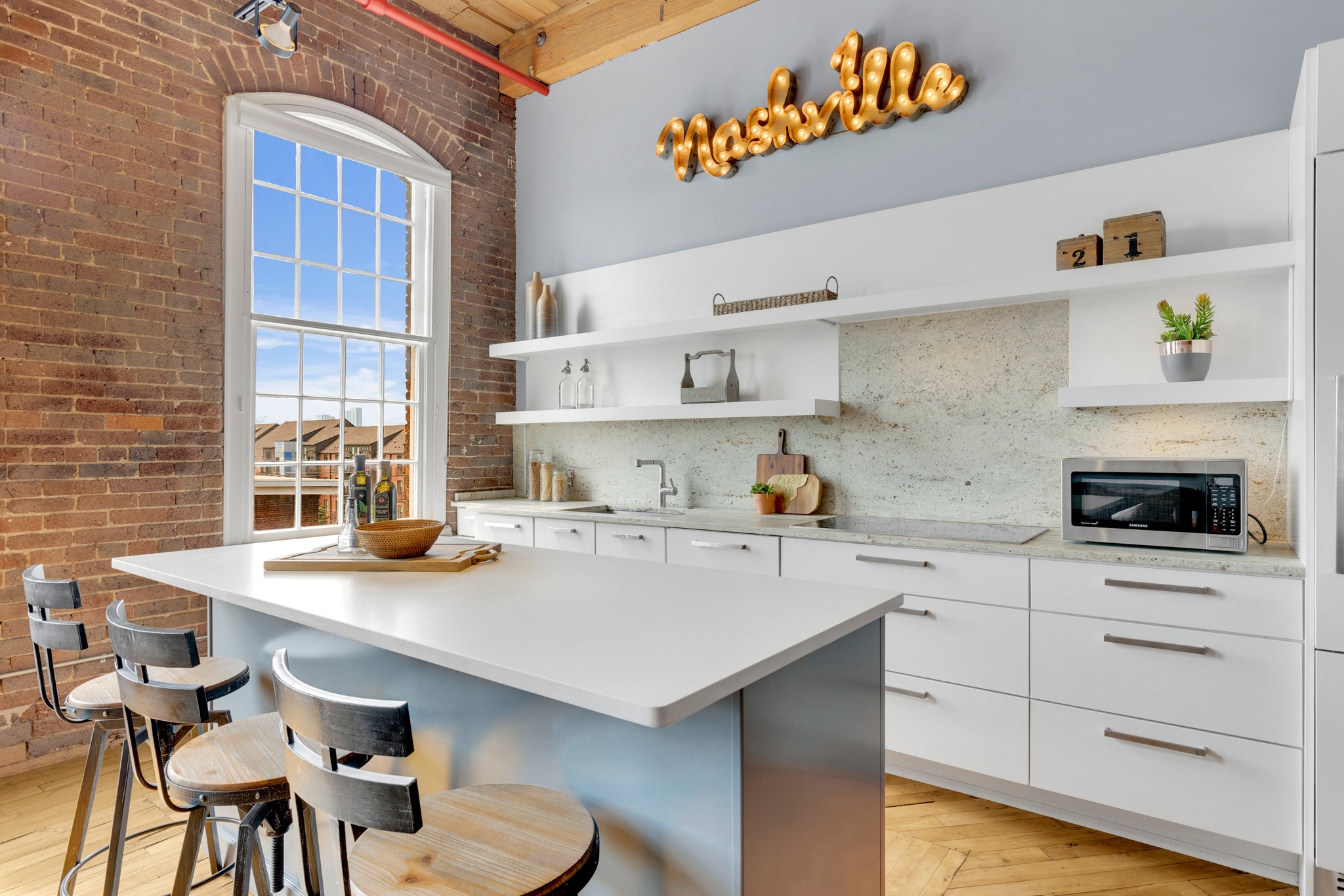 a kitchen with a sink cabinets and wooden floor