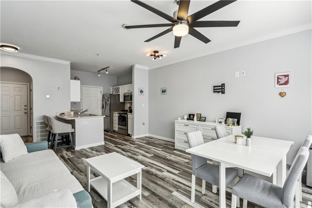 a living room with furniture and kitchen view