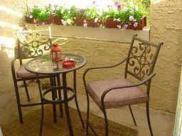 a view of a chairs and table in the terrace