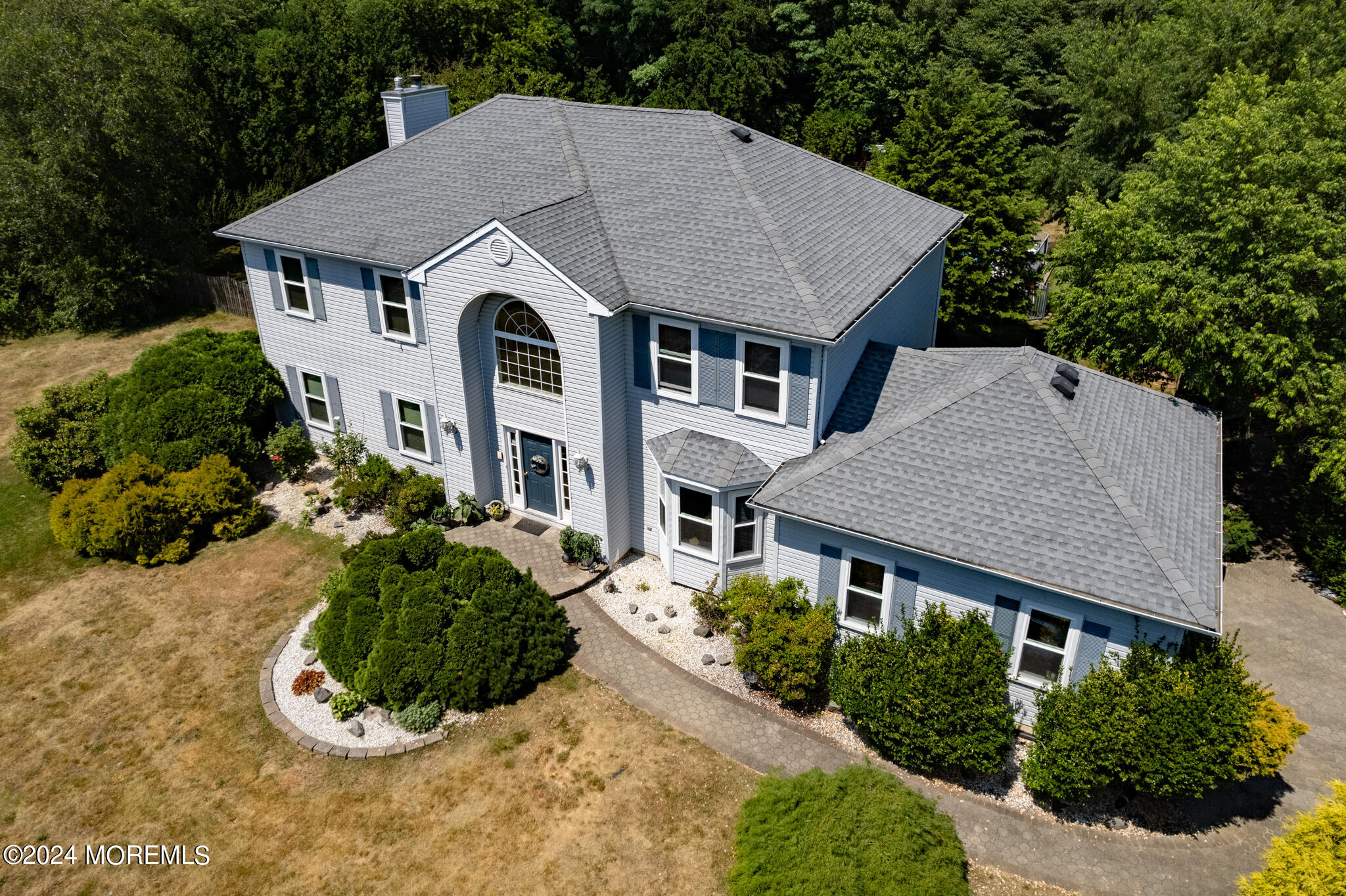 a aerial view of a house with a yard and potted plants