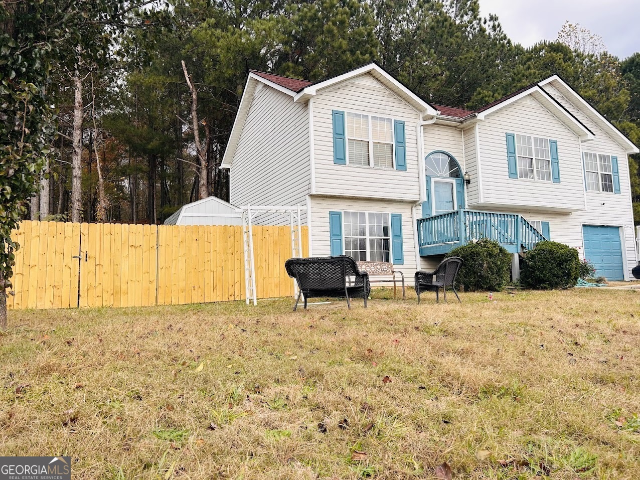 a view of a house with backyard and sitting area