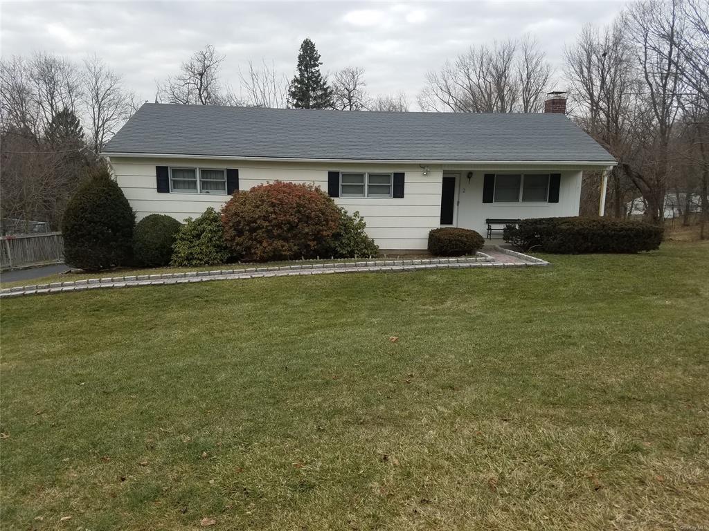 Ranch-style home with a front lawn