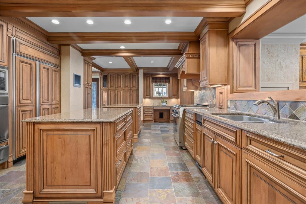 a kitchen with sink and refrigerator