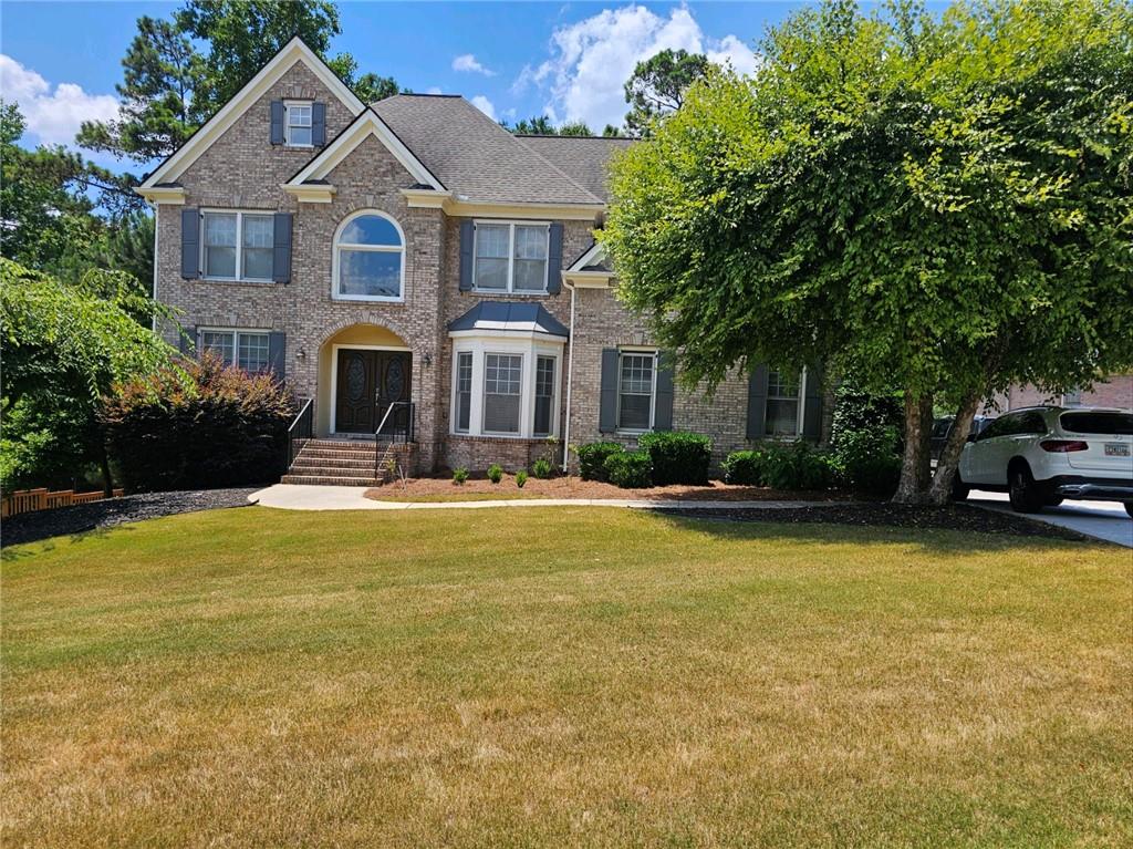 a front view of a house with swimming pool having outdoor seating