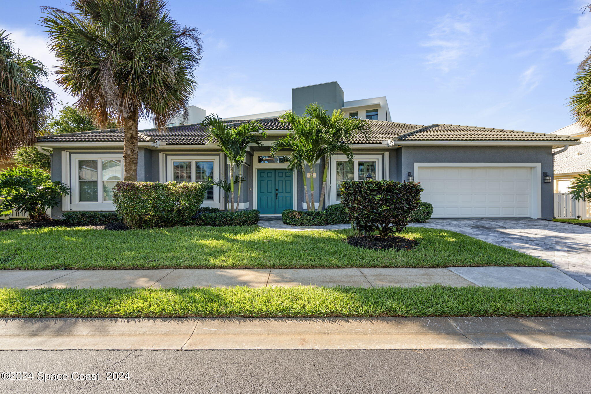 a front view of a house with a garden