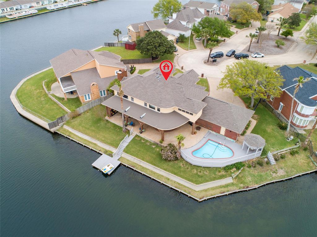 an aerial view of a house with a swimming pool patio and outdoor seating