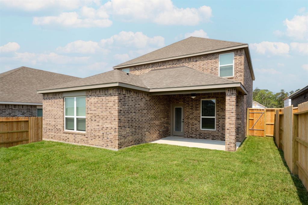 a view of a house with a small backyard