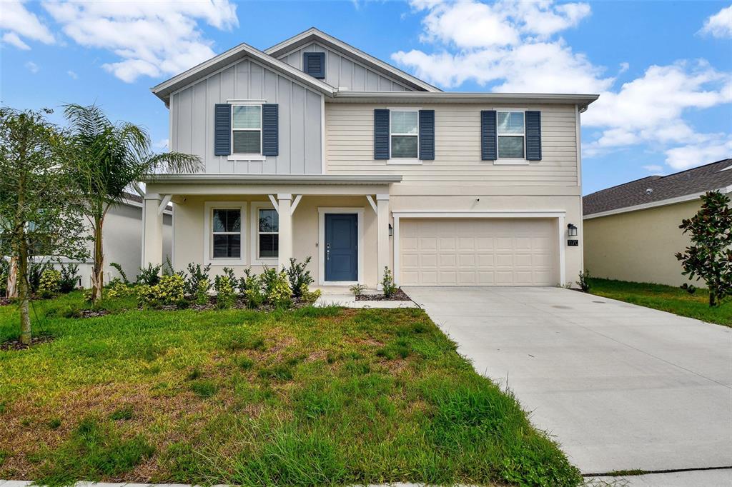 a front view of a house with a garden and yard