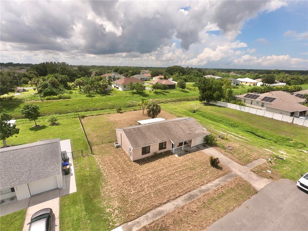 an aerial view of a house with big yard