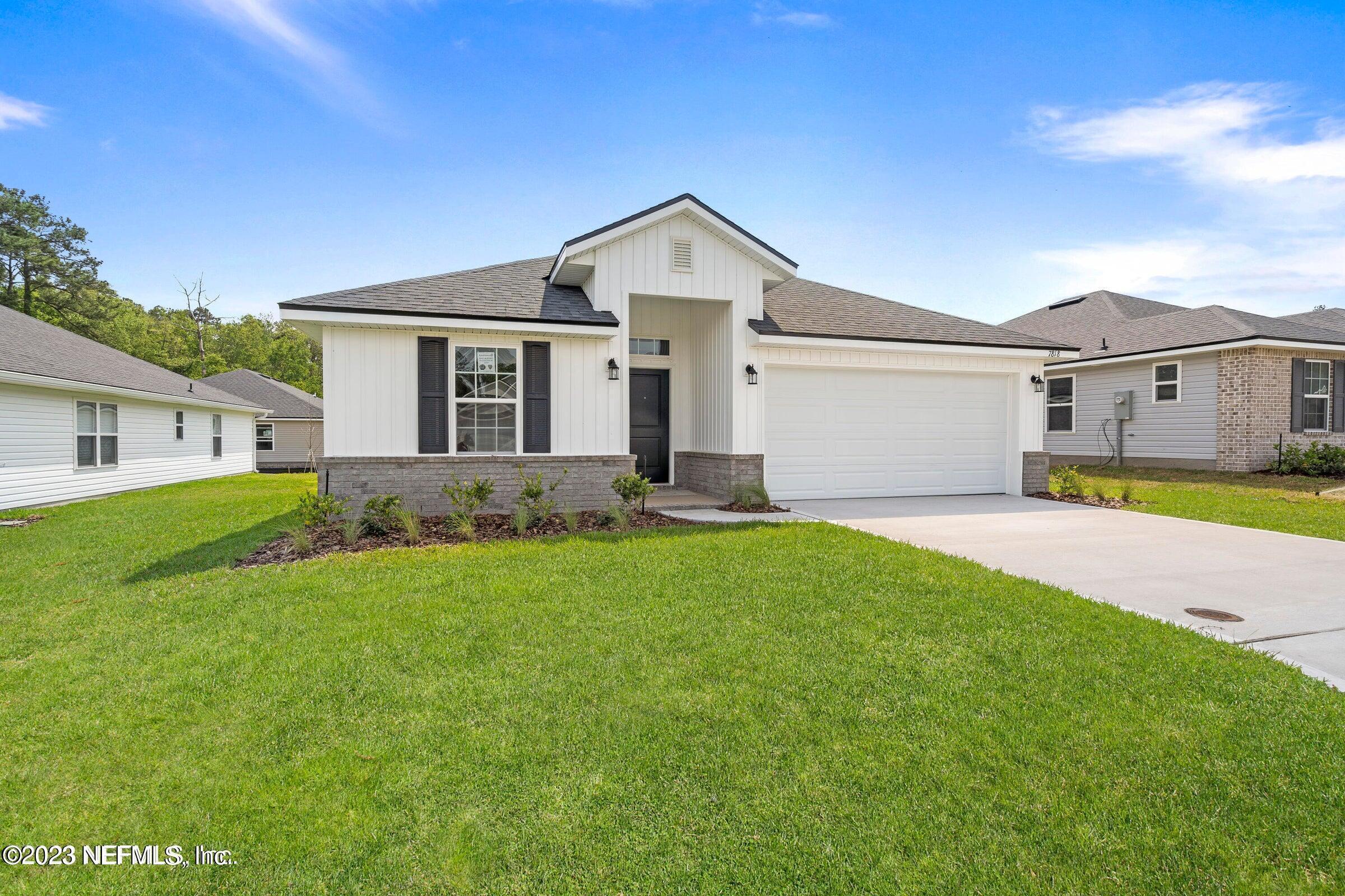 a front view of house with yard and green space