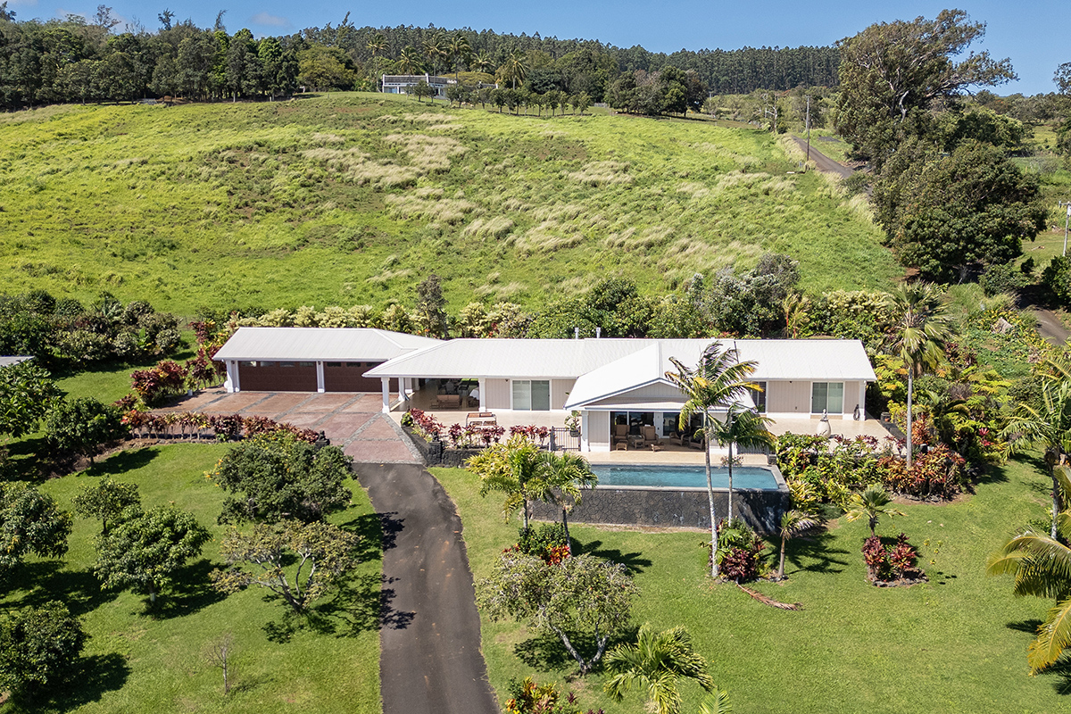 an aerial view of a house with a yard