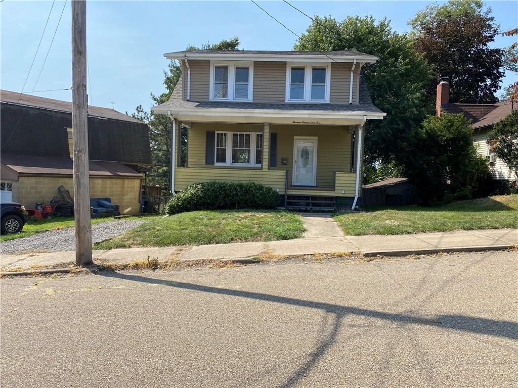 a front view of a house with a yard and a garage