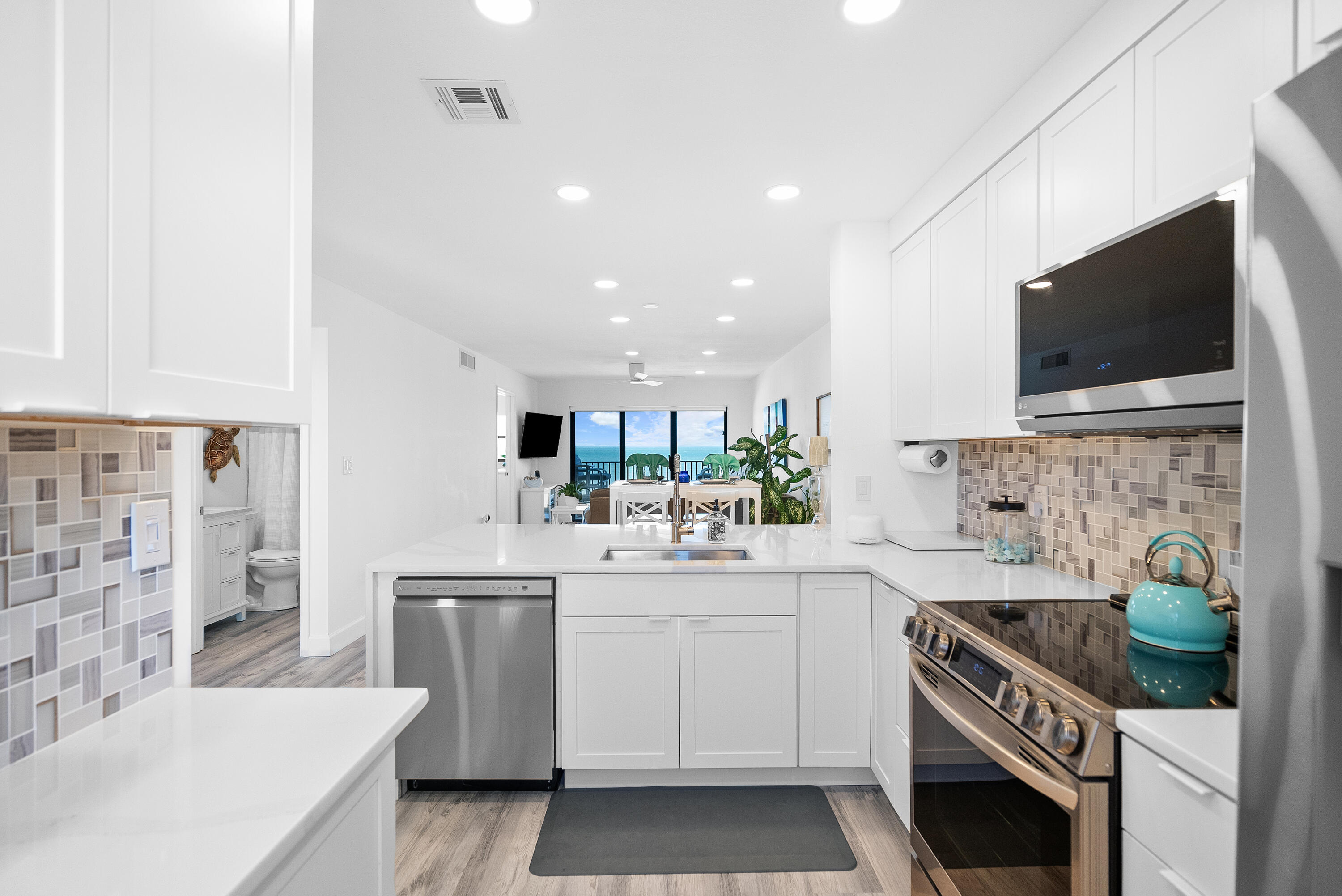 a kitchen with a sink stove and microwave