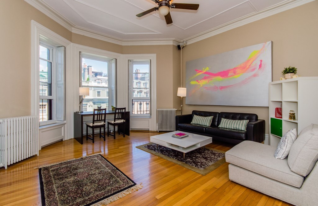 a living room with furniture rug and window