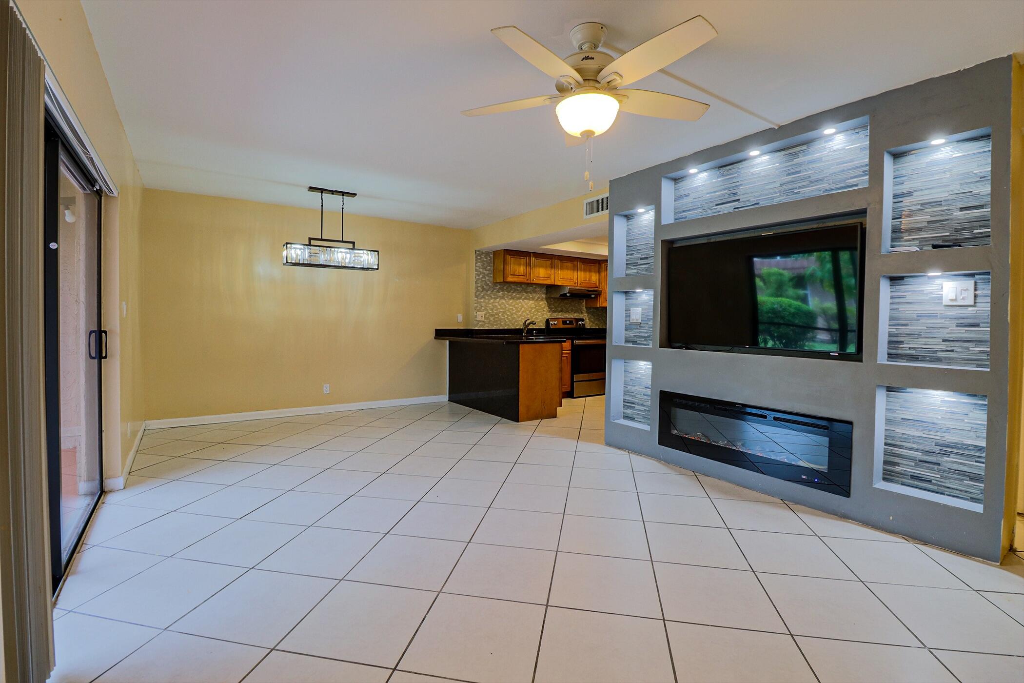 a kitchen with stainless steel appliances a stove a sink and a refrigerator with wooden floor