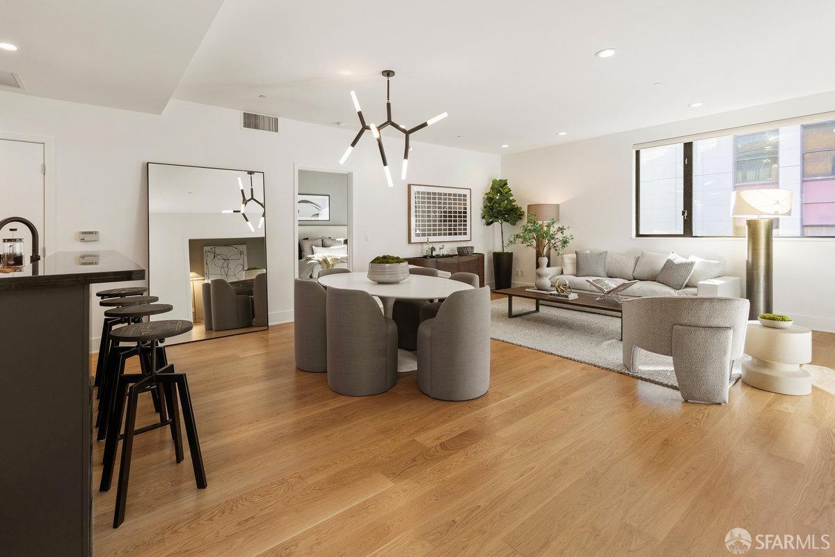 a living room with furniture a fireplace and wooden floor