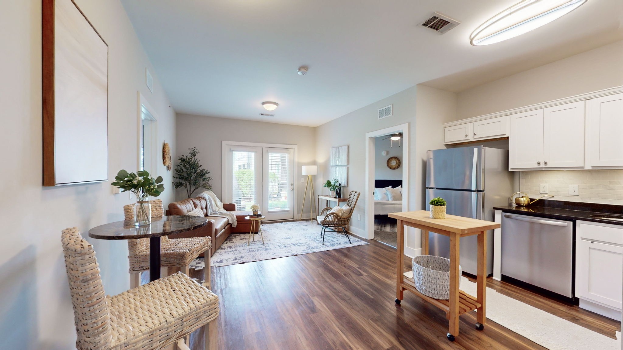 a living room with furniture dining table and wooden floor