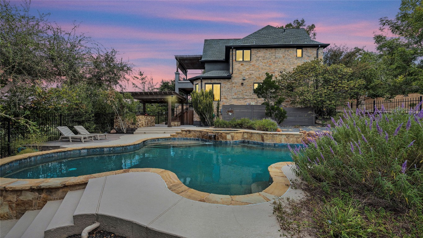 a view of a swimming pool in a backyard