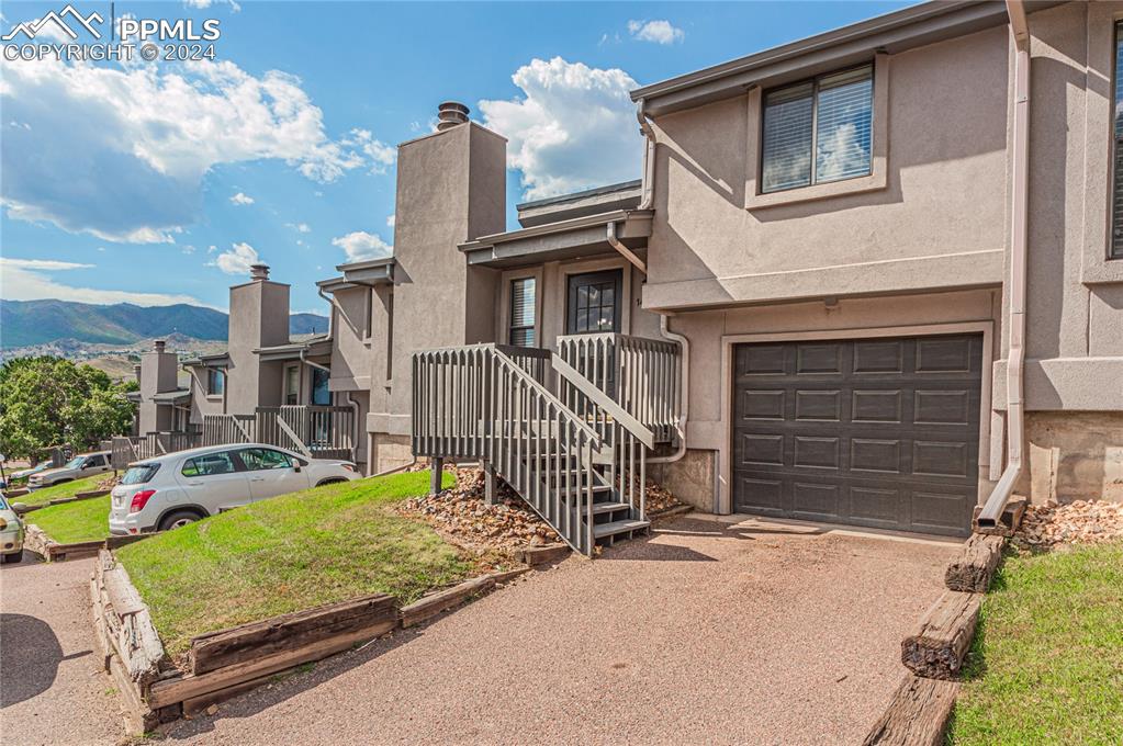 View of front of house featuring a mountain view and a garage