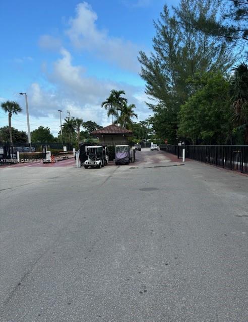 a view of a road with a cars parked in front of it