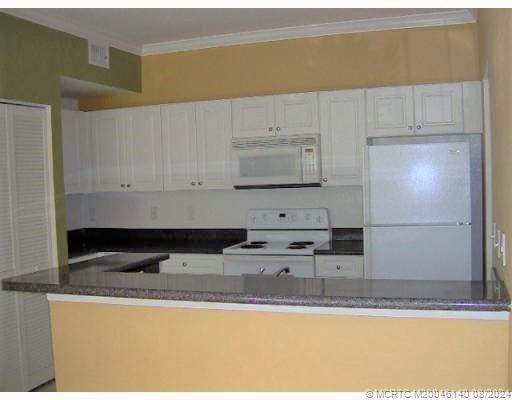 a kitchen with stainless steel appliances granite countertop a sink and a stove