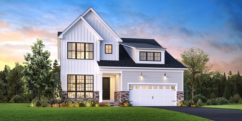 a front view of a house with a yard and garage