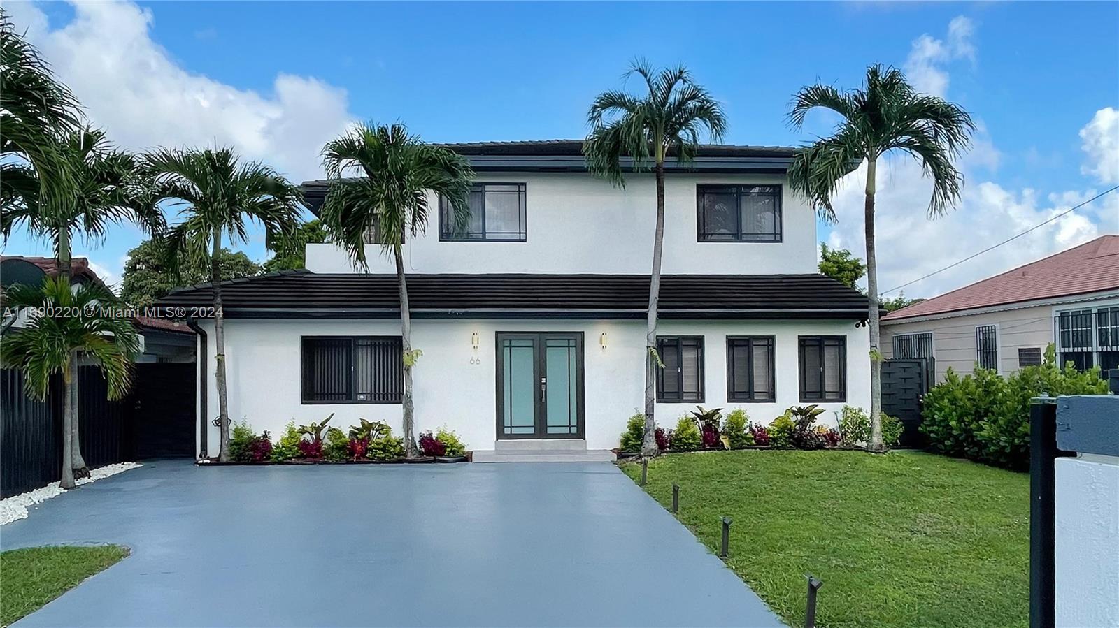 a front view of a house with a yard and a garage