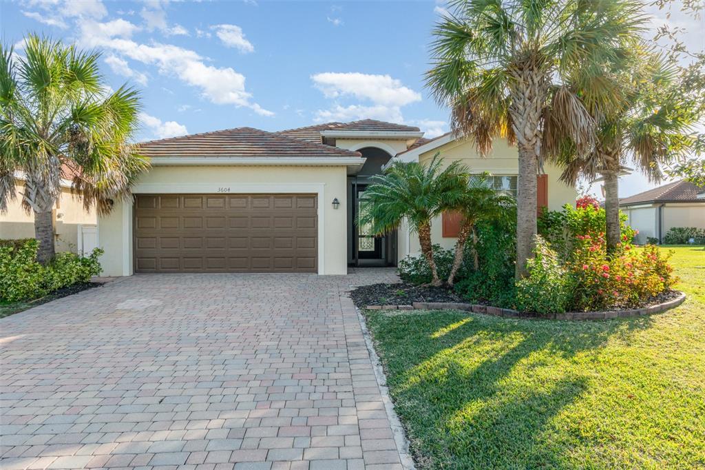 a front view of a house with a yard and garage