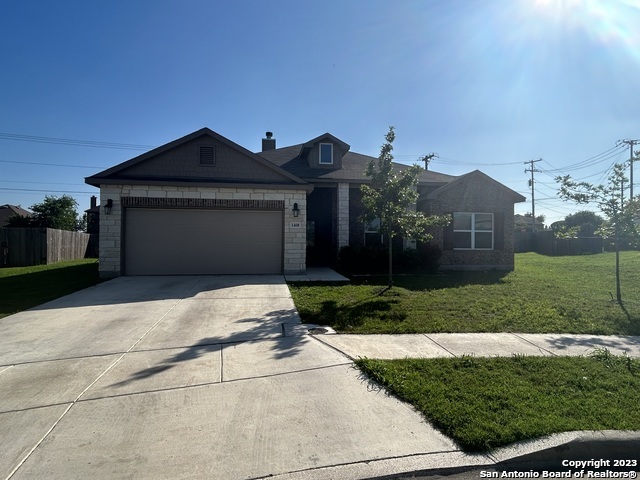 a front view of a house with a yard and garage