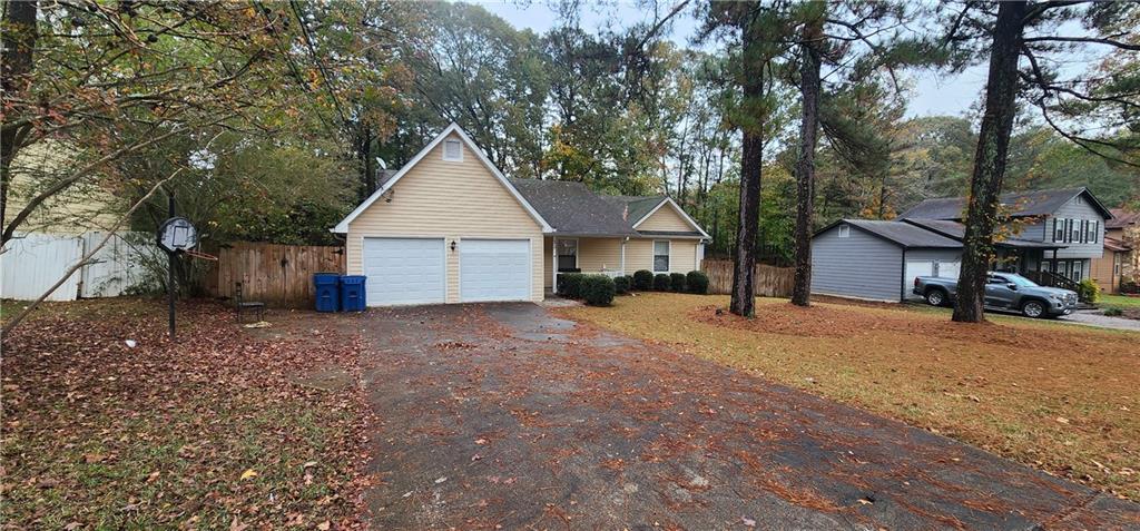 a view of a house with a yard and garage