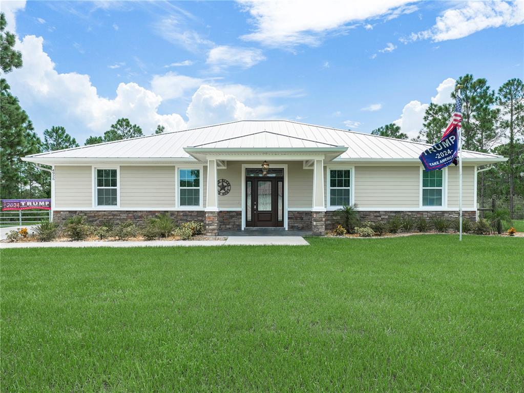 a front view of a house with a garden