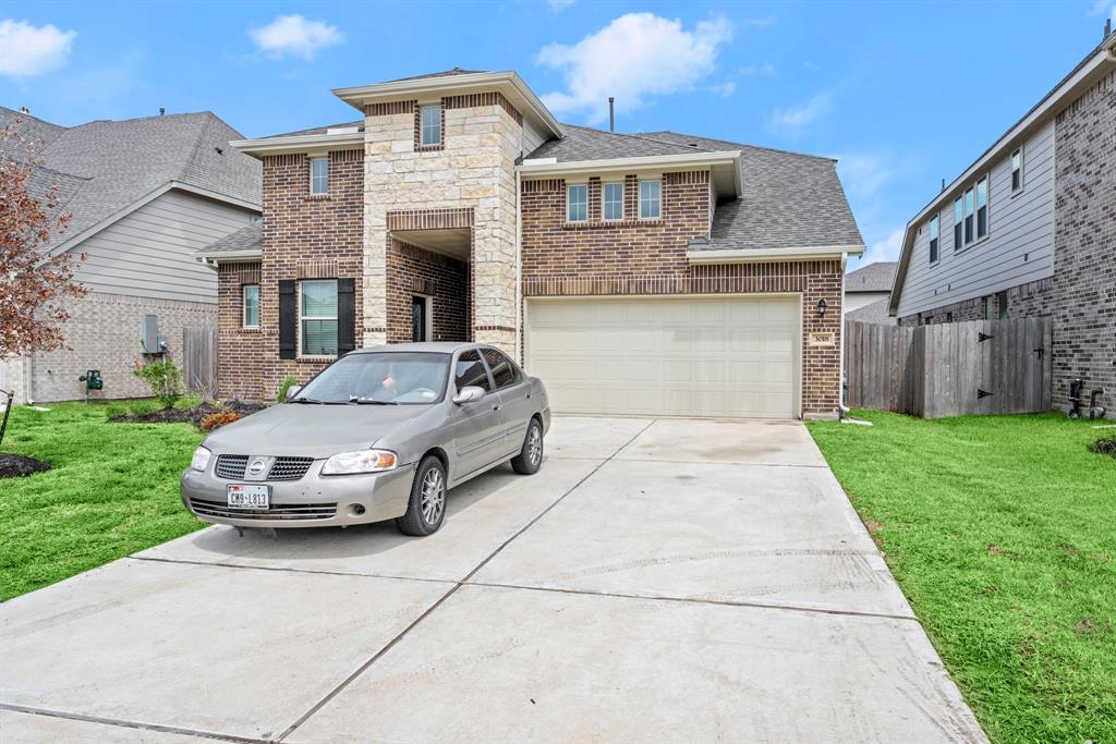 a car parked in front of a brick house