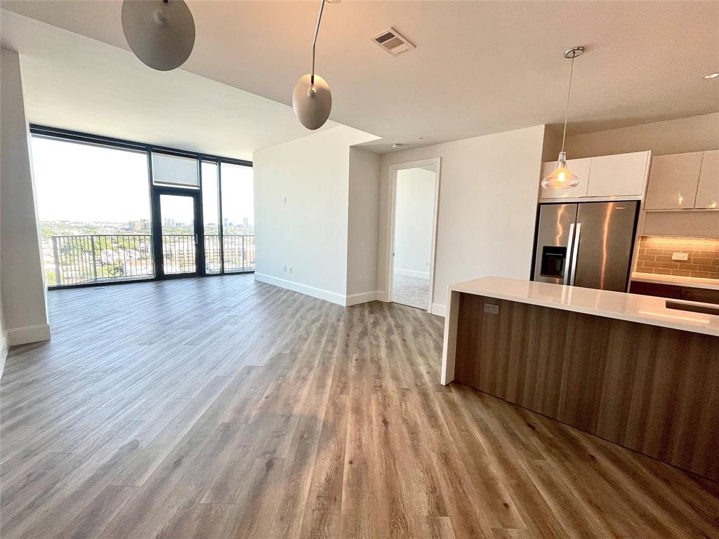 a view of wooden floor and windows in a room