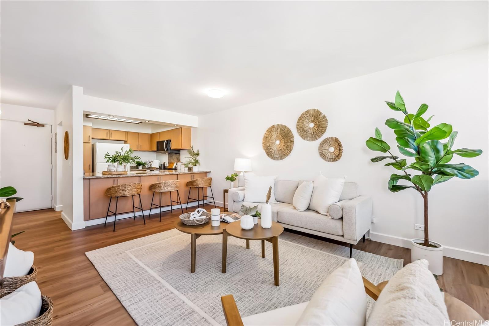 a living room with furniture cabinets and wooden floor