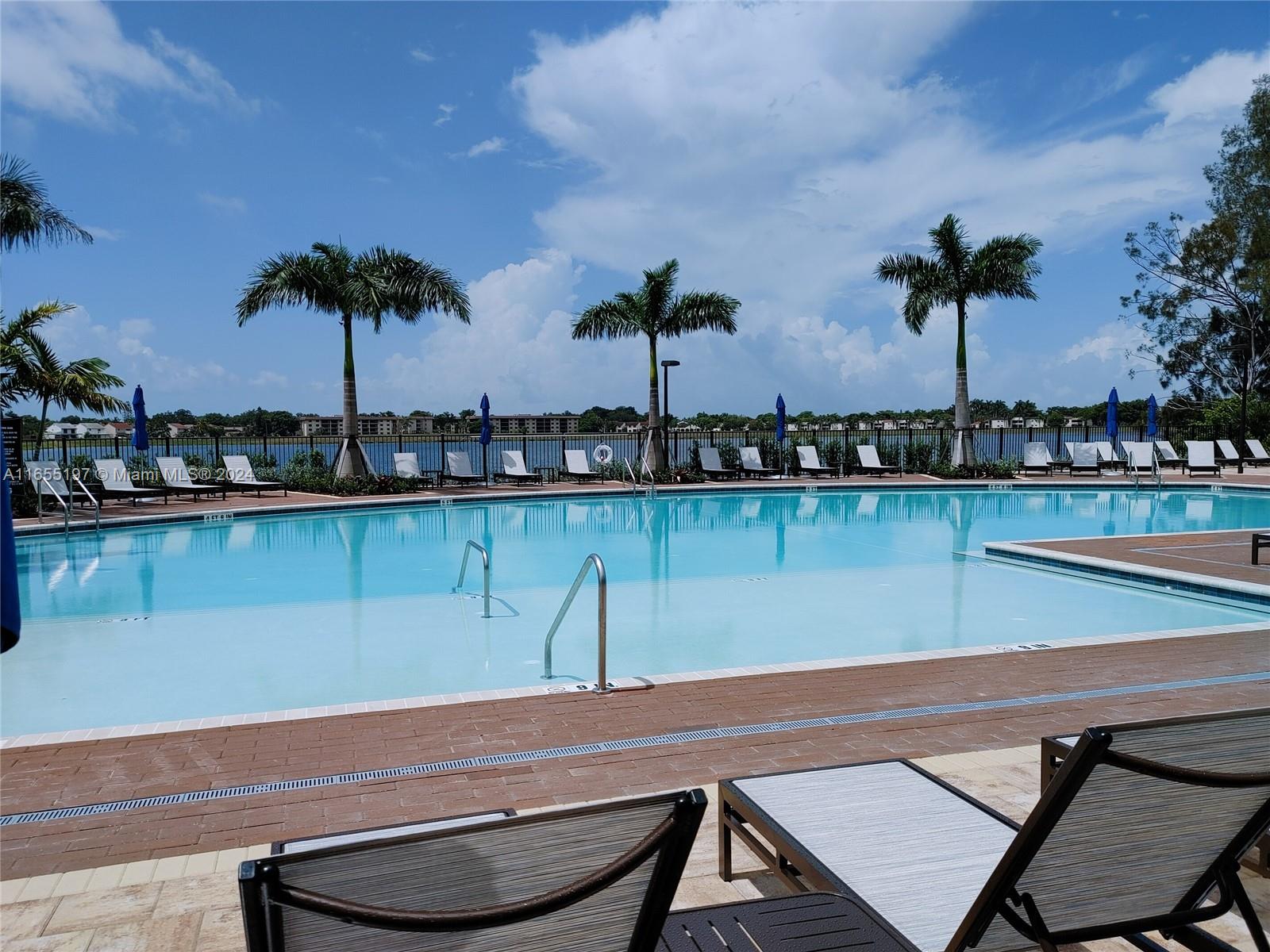 a view of a swimming pool with a table and chairs