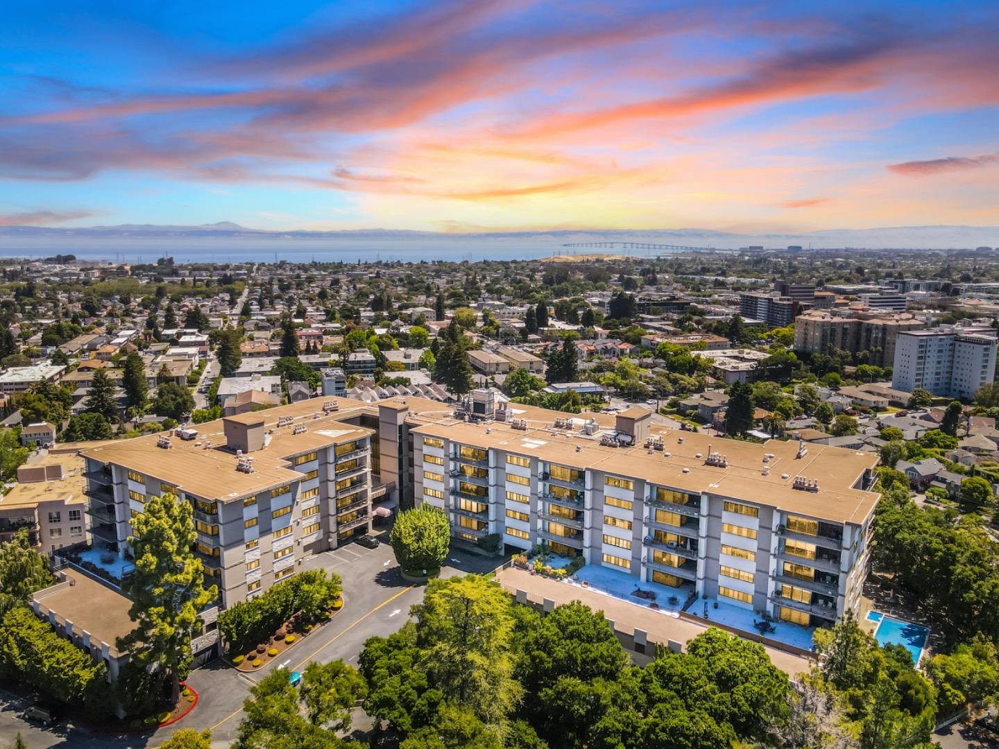 an aerial view of a multi story building with a yard