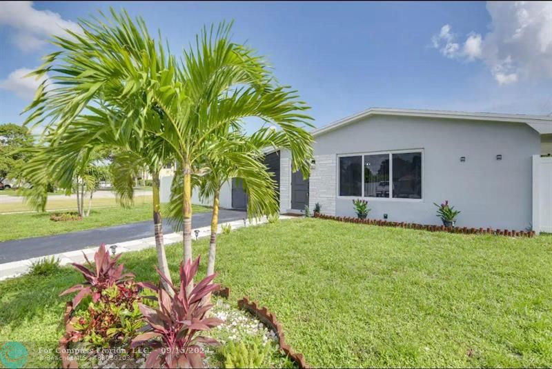 a front view of a house with a garden