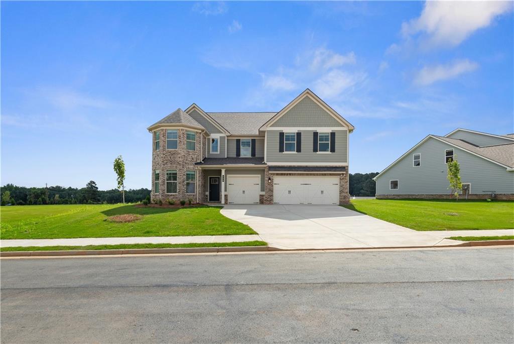 a front view of a house with a yard and garage