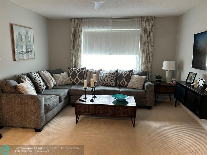 a living room with furniture and a lamp