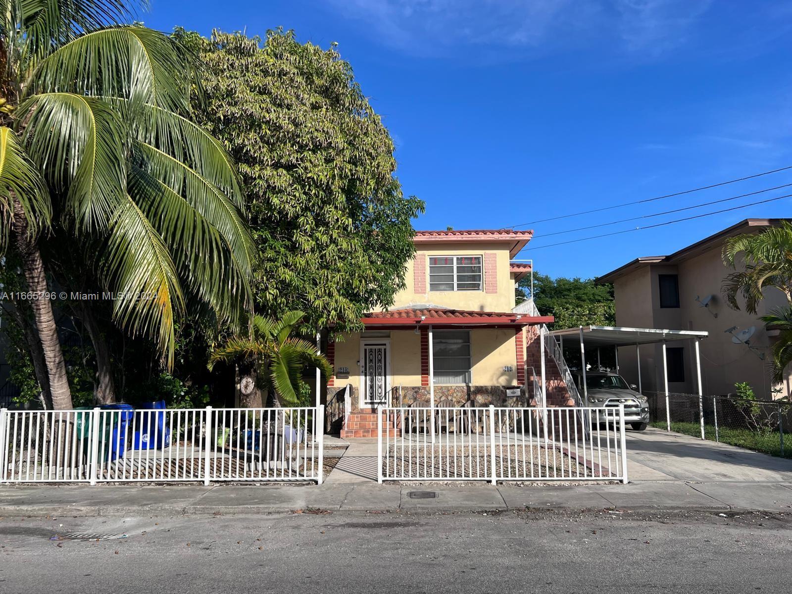 a view of a house with a iron gate